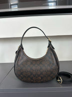 Brown handbag with a pattern on a gray surface