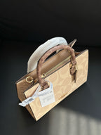 Designer handbag with a white hat inside on a dark background